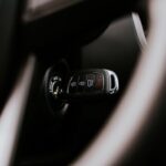 A close-up view of a car key placed in the ignition inside a vehicle, highlighting automotive detail.