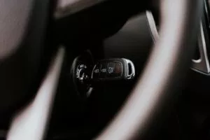 A close-up view of a car key placed in the ignition inside a vehicle, highlighting automotive detail.