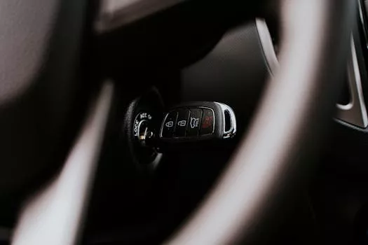 A close-up view of a car key placed in the ignition inside a vehicle, highlighting automotive detail.